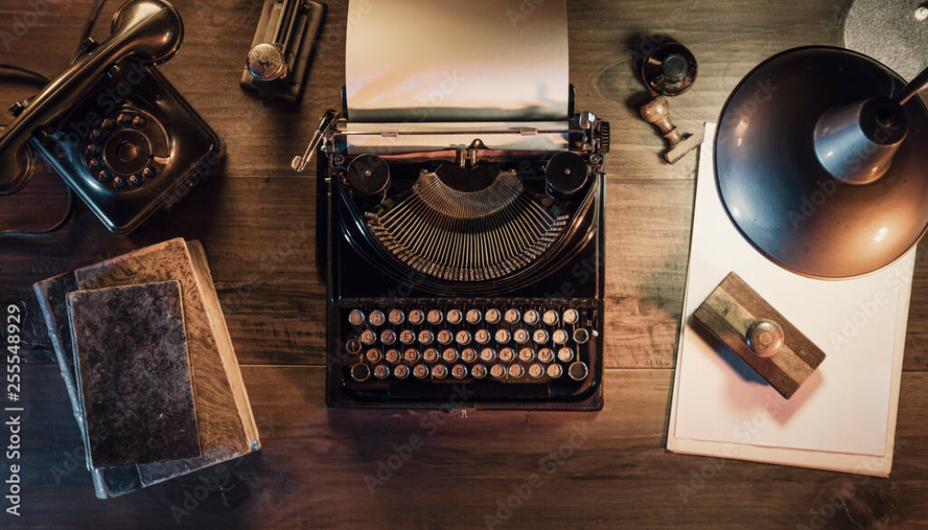 Vintage journalist desktop with typewriter and telephone