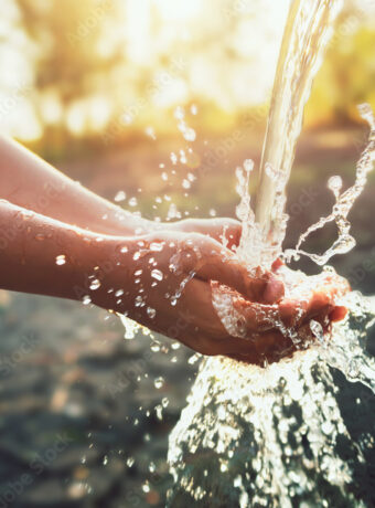 Water pouring on hand in morning ligth background